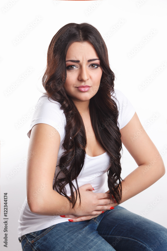 Woman in pain touching her stomach Woman in pain touching her stomach