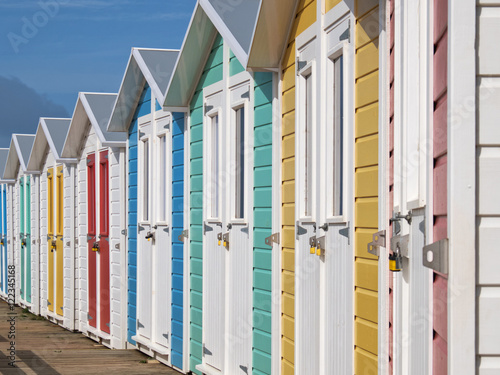 Row of locked English seaside chalets out of the vacation period