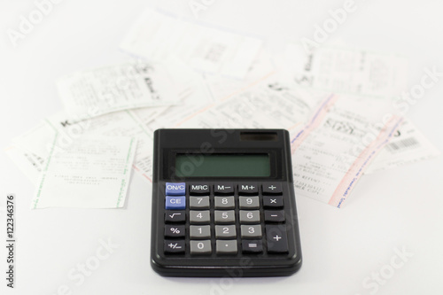 A calculator with receipt, household bills