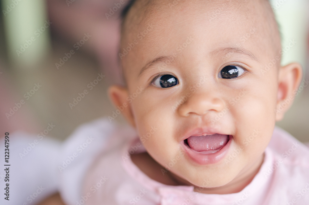 Cute laughing and smiling baby girl at home
