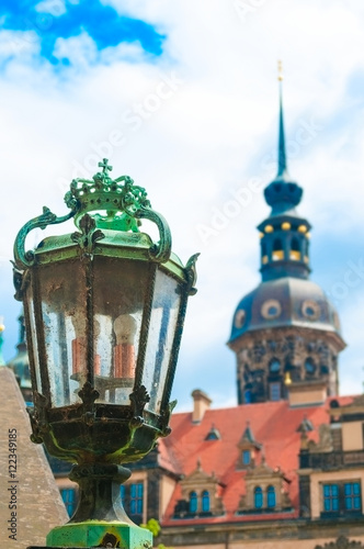 Antique lantern closeup and cathedral against blue sky