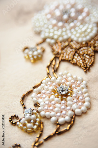 Luxury wedding background with rhinestone and bead embroidery closeup