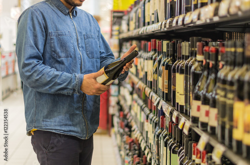 Buying wine at the supermarket. photo