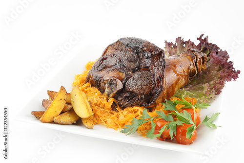 Fried pork knuckle with potatoes and tomato