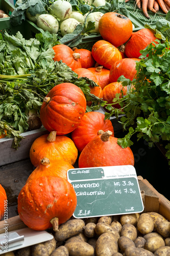 Pumpkins and other vegetables on a market stall