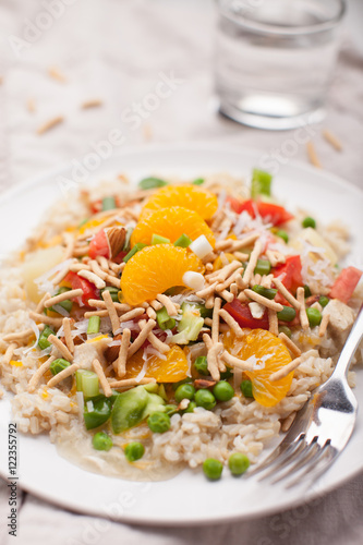 Fotografie Hawaiian haystacks meal with chicken, sauce, brown rice, mandarin oranges, and o