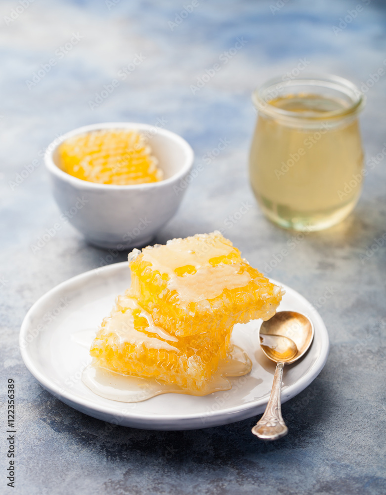Honey, honeycombs on a grey stone background Honey, honeycombs on a grey stone background