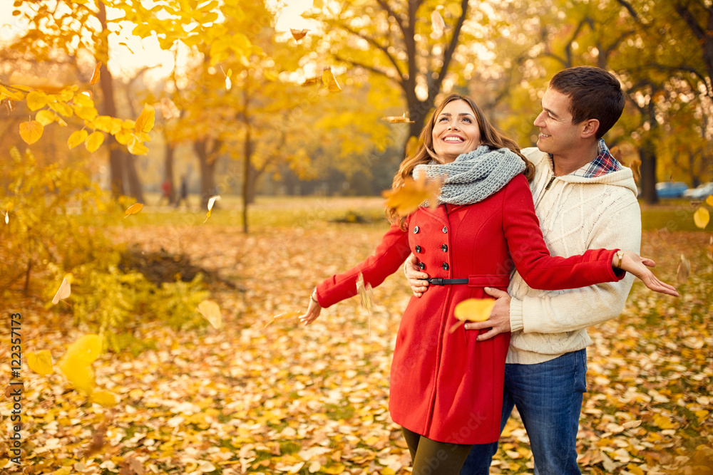 Love couple in autumn walking in park Love couple in autumn walking in park