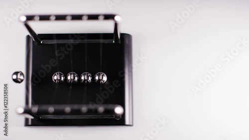 Newton’s cradle chrome balls swinging with copy space