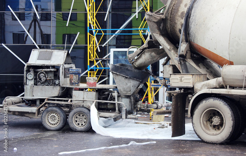 concrete pump and  mixer to work together  pouring cement floors in the shopping center for repair. photo