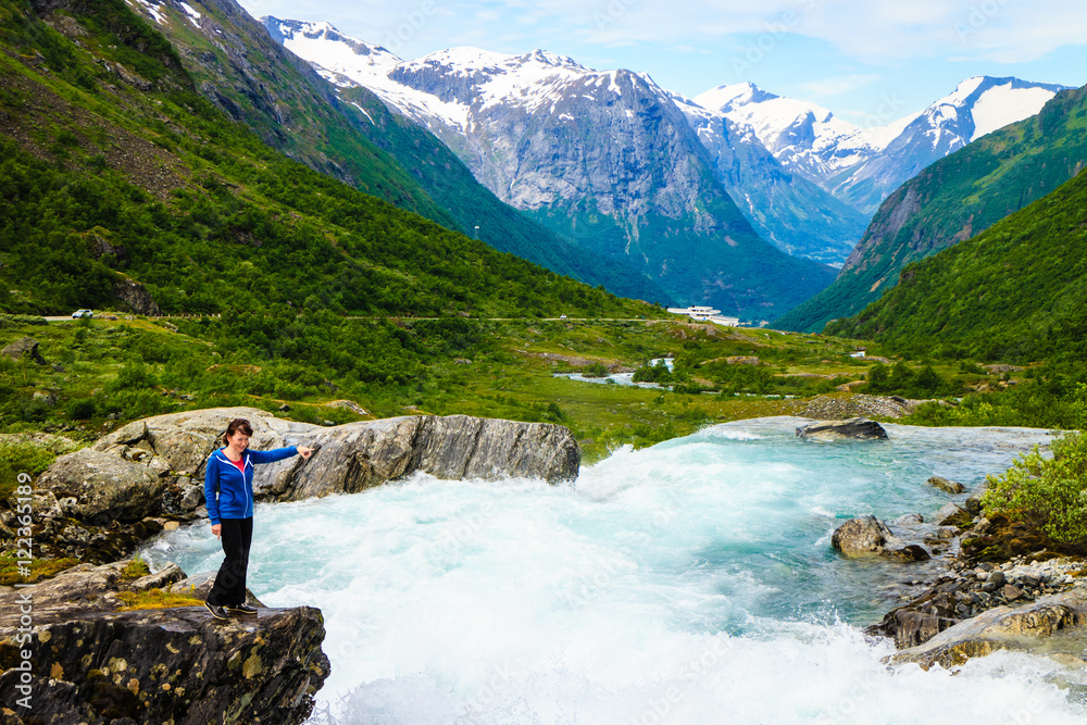 Naklejka premium Tourist woman by Videfossen Waterfall in Norway