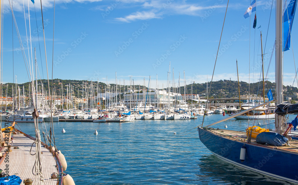 Obraz premium CANNES, FRANCE - 19 SEPTEMBER, 2016: Vieux Port (old port) in the city of Cannes, with lots of sailing boats and power yachts anchored during the Sailing regatta