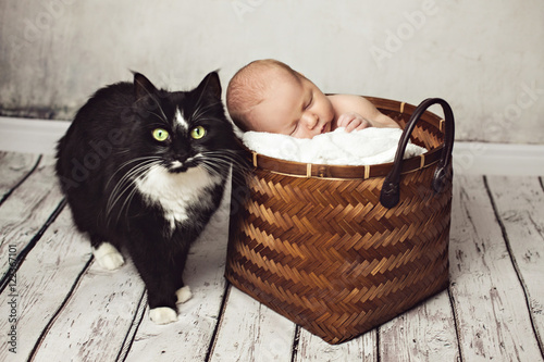 Baby Is Sleeping Near A Big Black Cat