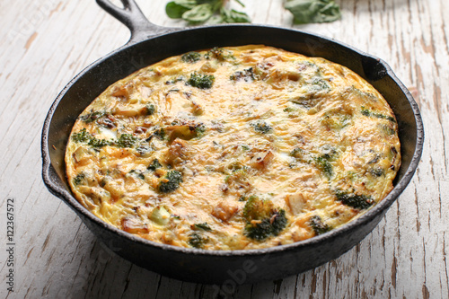 Baked egg frittata with spinach, cheese, broccoli, red potatoes, bacon, milk, and spinach horizontal view
