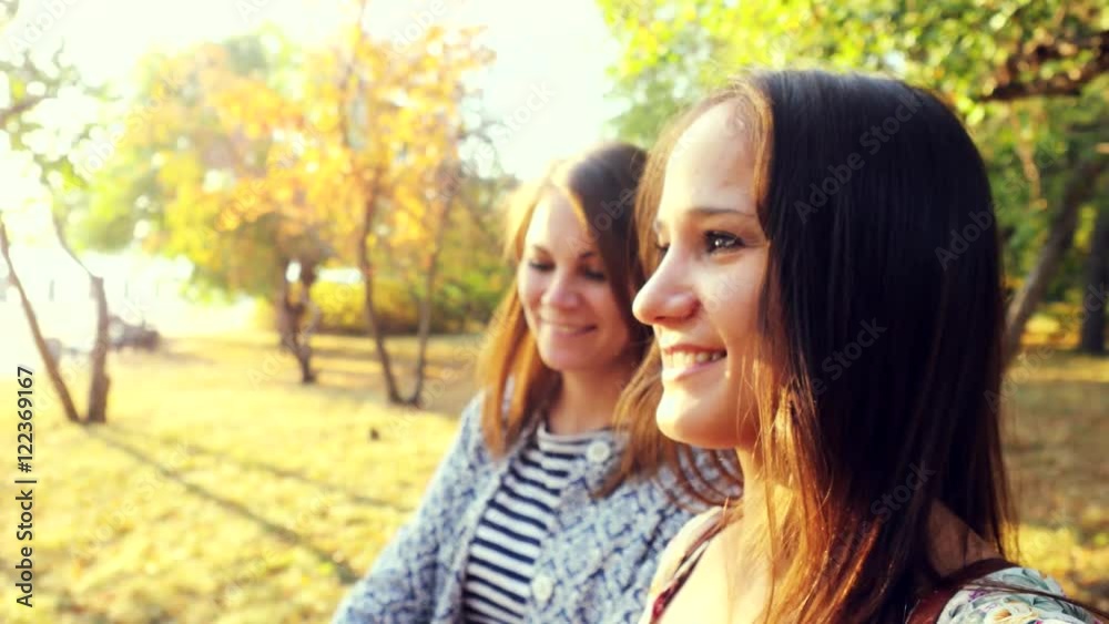 Beautiful girls walking in autumn park in sunny day on the sunshine background. 3840x2160