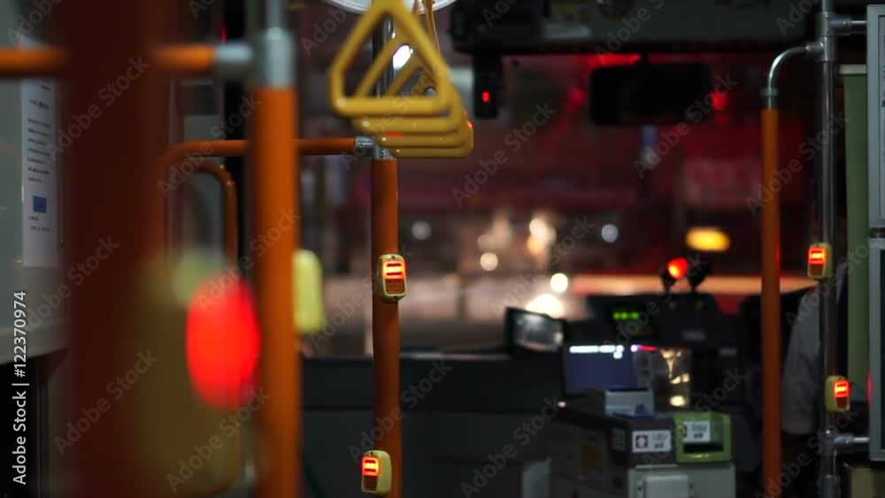 View of handle inside the night city bus. Abstract public transportation in Asia. 