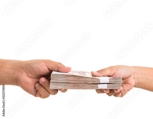Hand giving Thai banknotes. Studio shot isolated on white backgr