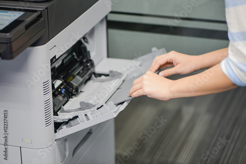Business woman is repairing the printer