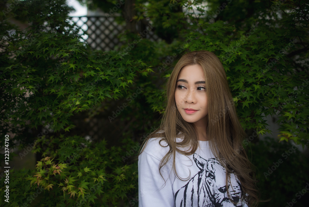 Happy Asian Girl in a park during Autumn season. Portrait of a y Happy Asian Girl in a park during Autumn season. Portrait of a y