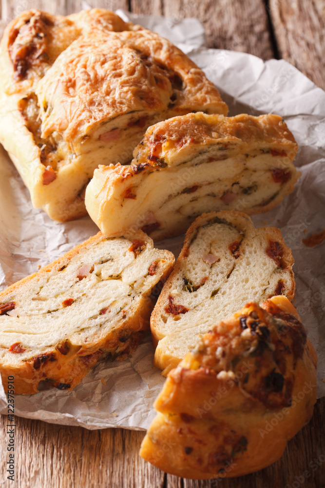 sliced bread stuffed with cheese and bacon and dried tomatoes close-up. vertical
sliced bread stuffed with cheese and bacon and dried tomatoes close-up. vertical