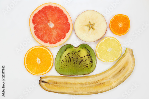 thin slicing different fruits on white background