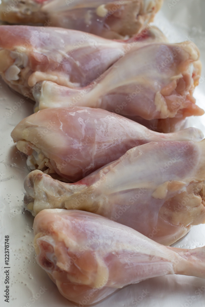 Raw meat. Ready to cook chicken legs. Skinless chicken drumsticks with herbs. Raw meat. Ready to cook chicken legs. Skinless chicken drumsticks with herbs.