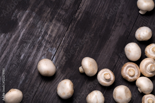 Fresh raw chestnut mushrooms on black table