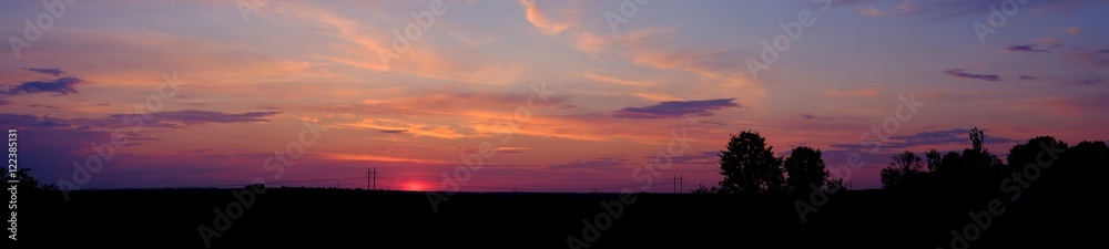Panorama of sunset over the field