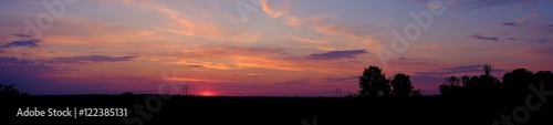 Panorama of sunset over the field