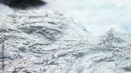 A shot of the sacred River Ganges flowing past rocks at the holy town of Rishikesh in North India. photo