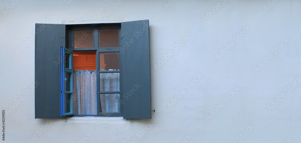 With open window shutters on the farmhouse.