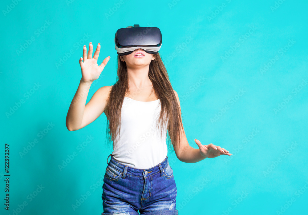 Sexy young girl with glasses of virtual reality on a blue background. Sexy young girl with glasses of virtual reality on a blue background.
