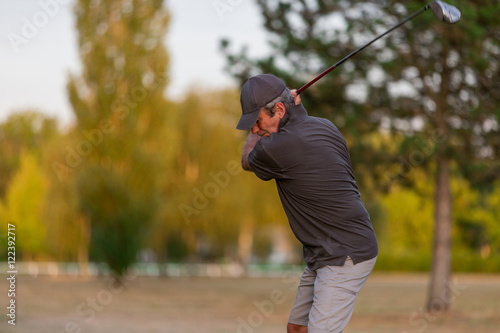 senior playing golf