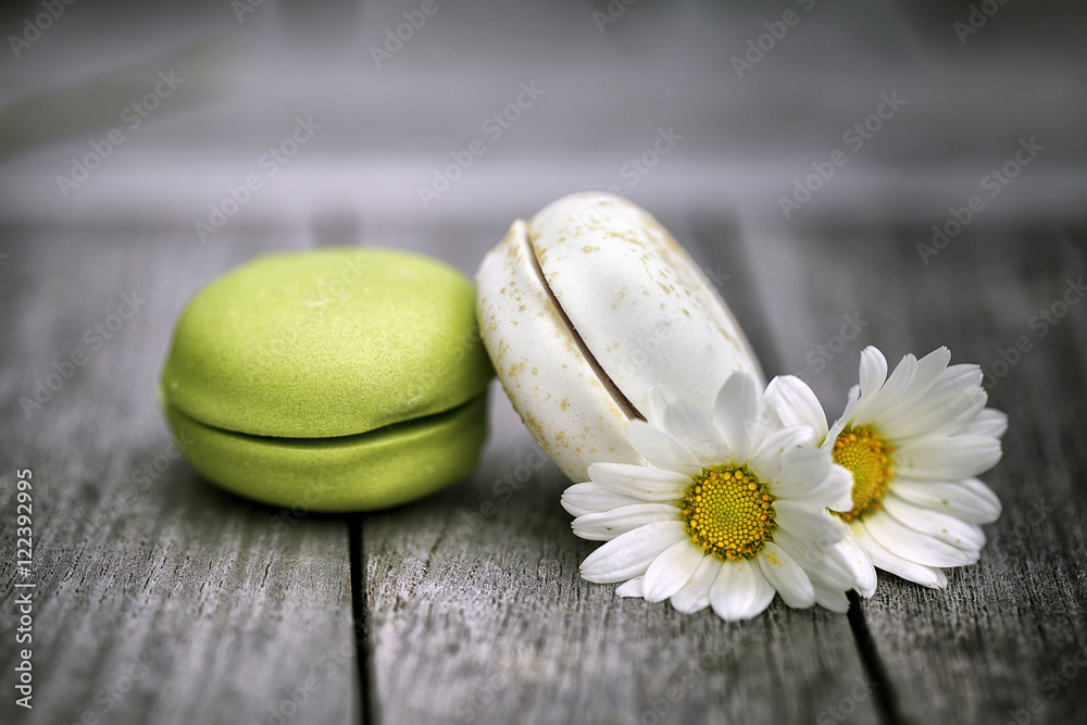 Macarons with Daisy Flowers on rustic wooden Table Macarons with Daisy Flowers on rustic wooden Table