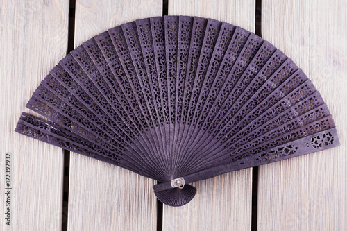 Black fan over wooden table