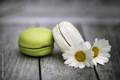 Macarons with Daisy Flowers on rustic wooden Table