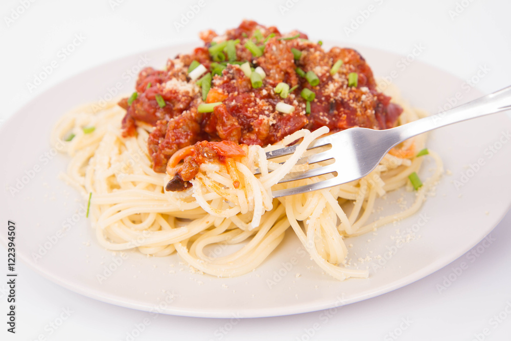 Spaghetti bolognese being eaten with a fork Spaghetti bolognese being eaten with a fork