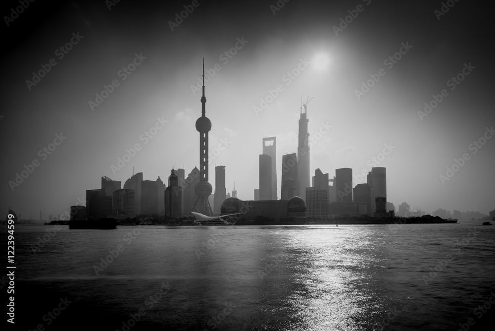 Shanghai sunrise silhouette with Oriental Pearl Tower, Huangpu River, Pudong district, Shanghai, China. Black and White, Long exposure with ND Grad filter, visible noise.