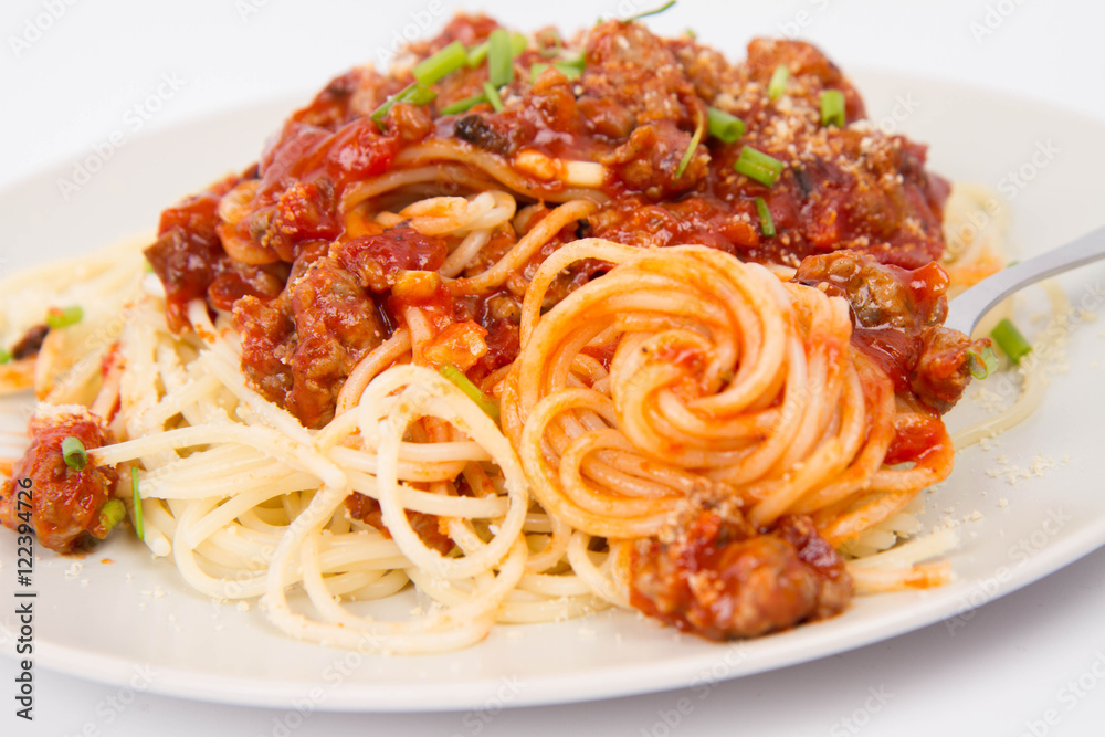 Spaghetti bolognese being eaten with a fork Spaghetti bolognese being eaten with a fork