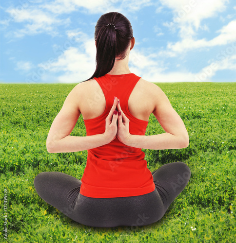 Young woman practicing yoga...
