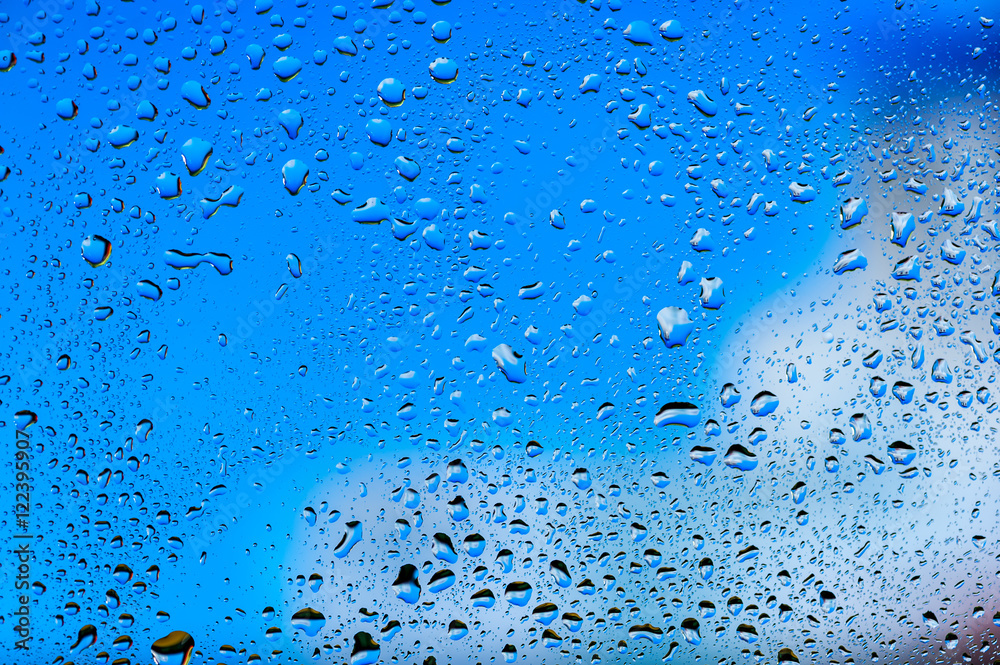 Abstract texture. Water drops on glass with blue background