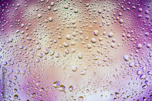 Abstract texture. Water drops on glass with purple background