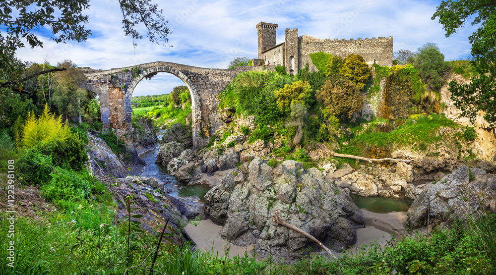 Fototapeta premium Italy Vulci Castello dell Abbadia medieval castle and ancient Etruscan city and bridge historic landmark Lazio regio, archeological site roman heritage architecture heritage 