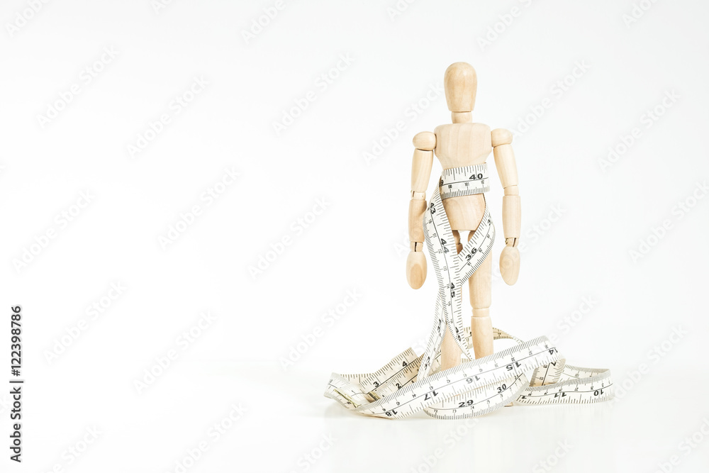 Wooden figure with measurement tape, on white background