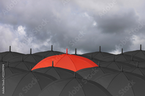 Red umbrella and Surrounded by a black umbrella.