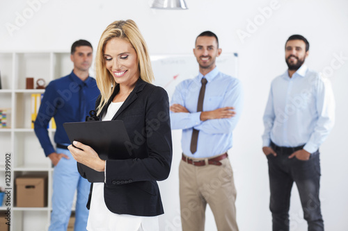 Portrait Of Young Businesswoman With Business Team