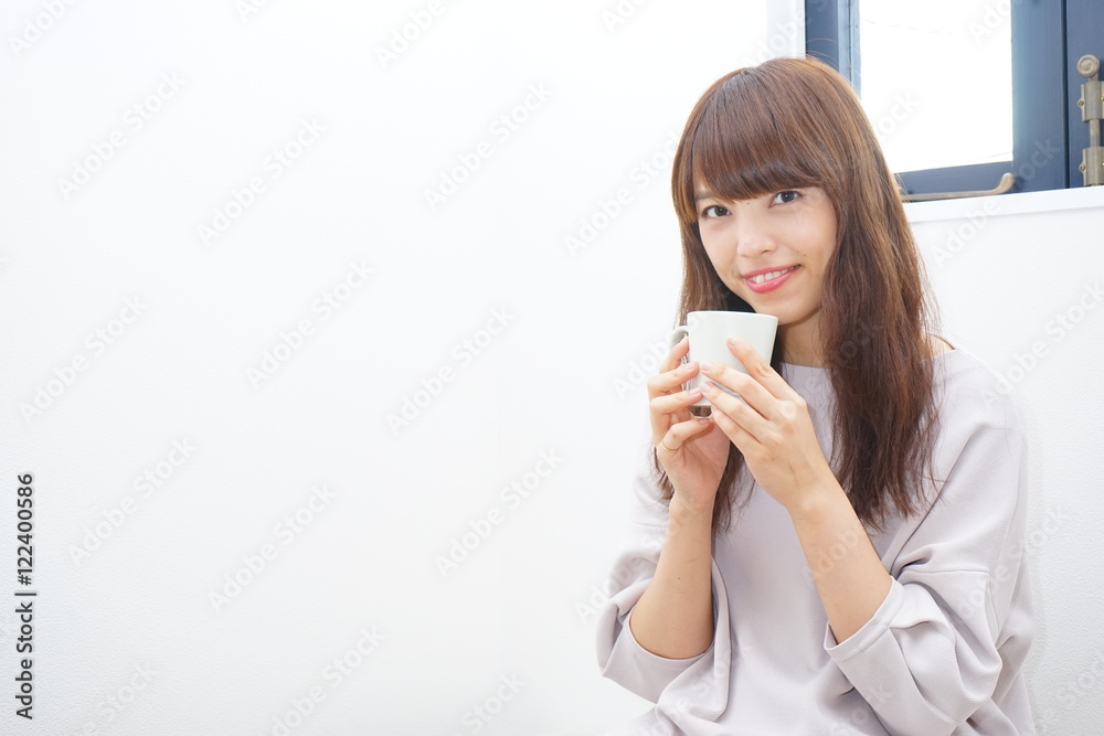 Young Japanese woman relaxing in her room with smile Young Japanese woman relaxing in her room with smile