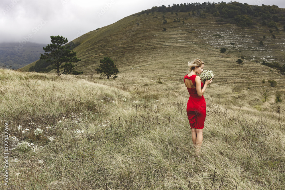 Woman in red dress, bouquet, mountains Woman in red dress, bouquet, mountains