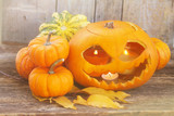 orange halloween carved pumpkin on wooden table