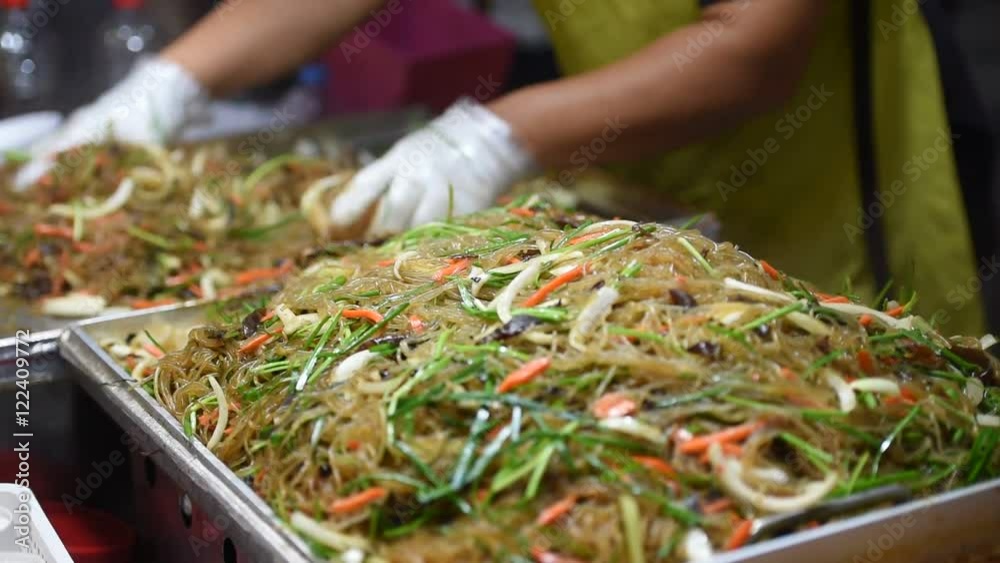 Asian market - a man cooking the street food